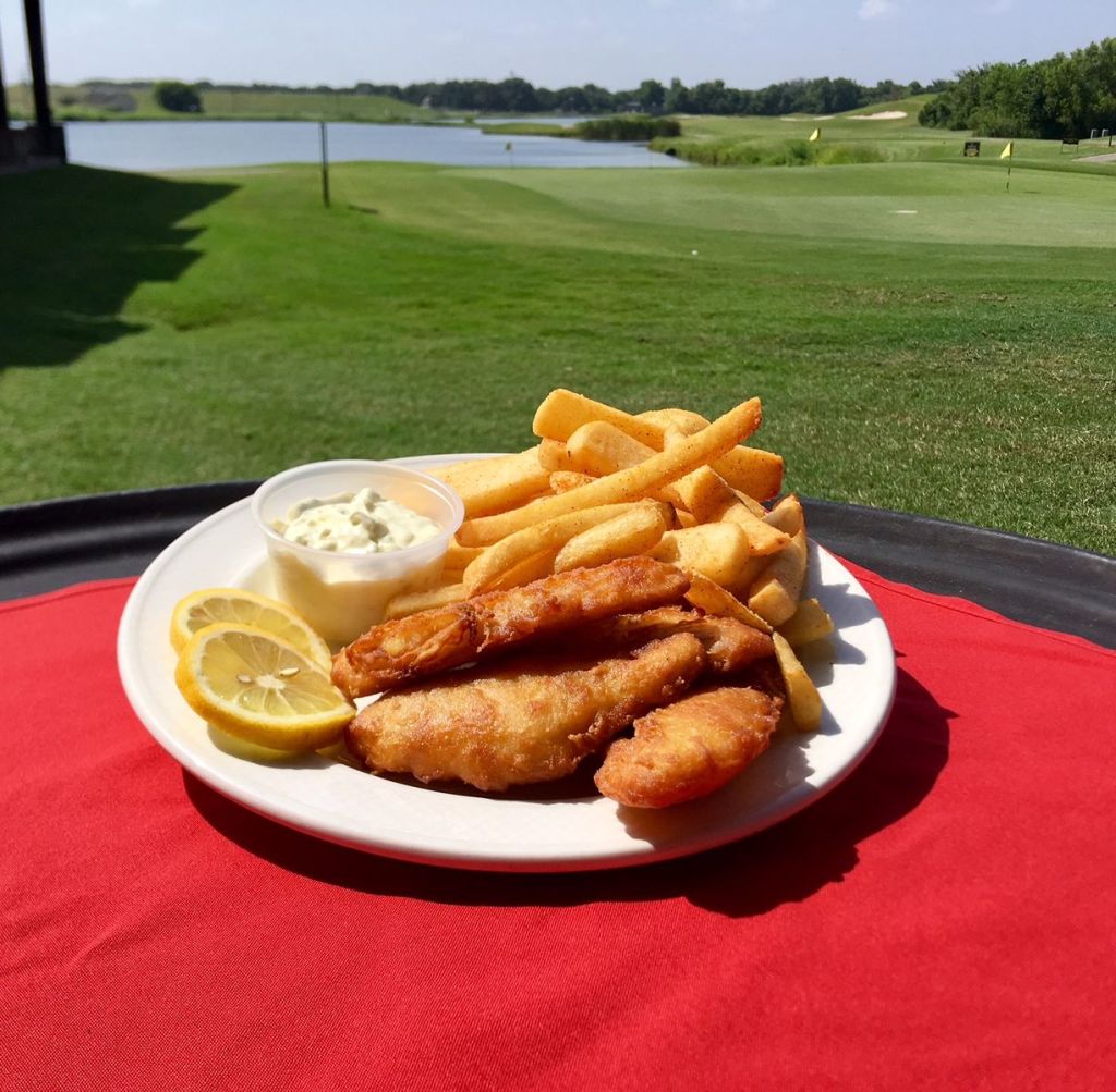 A lunch of fried fish and fries outside on the course